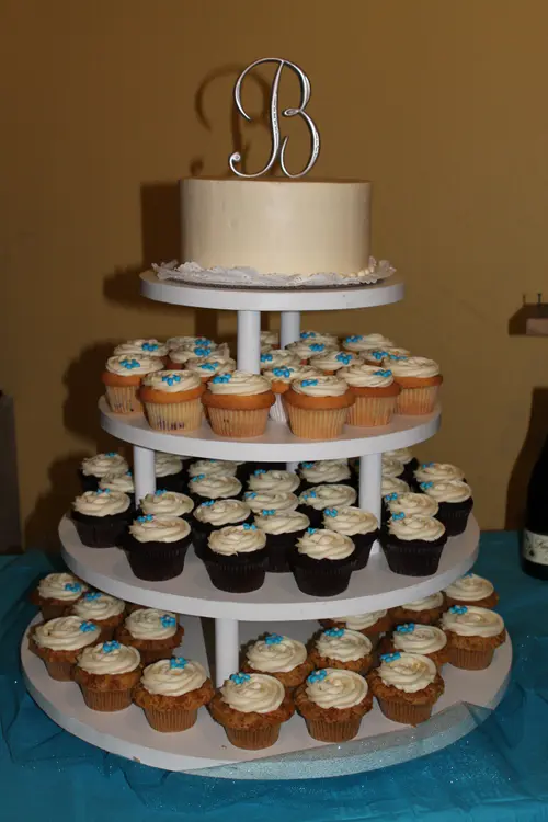 Wedding cake: Cupcake #2. Cream cheese icing; chocolate, carrot and white cupcakes with filling, light blue accents.