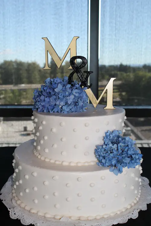Wedding cake: Hydrangea #1. Vanilla buttercream. Topper provided by customer.