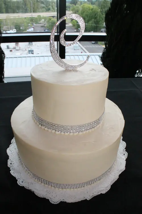 Wedding cake: Ribbon #1. Cream cheese icing. Topper and crystal ribbon provided by customer.