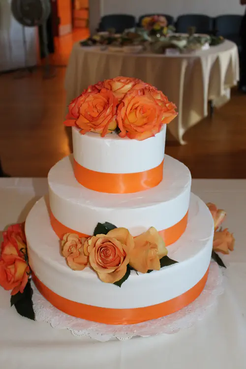 Wedding cake: Roses #1. Vanilla buttercream. Flowers and ribbon provided by customer.