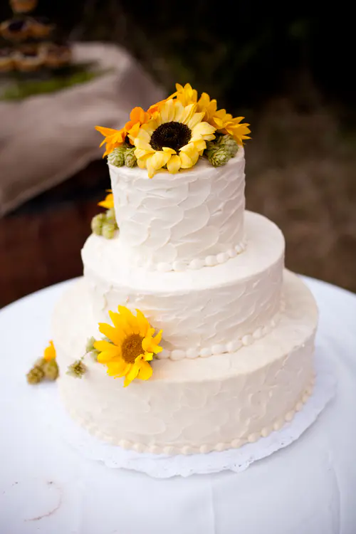 Wedding cake: Rustic #1. Cream cheese icing. Sunflowers and hops provided by customer.